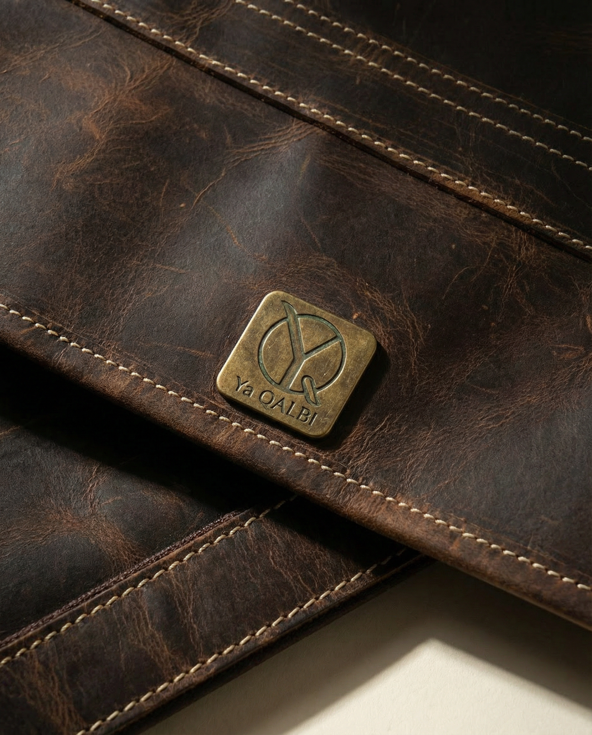 Close-up of logo plate on distressed buffalo leather