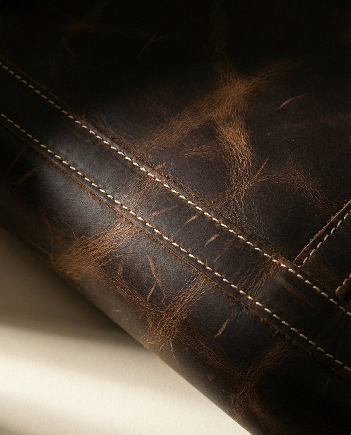 Close-up of stitching on dark brown buffalo leather