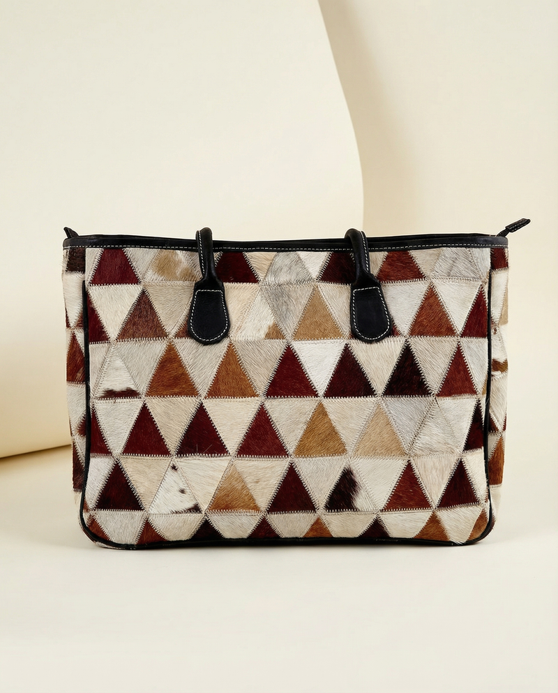 Leather laptop tote with hair-on patchwork detail by Ya Qalbi