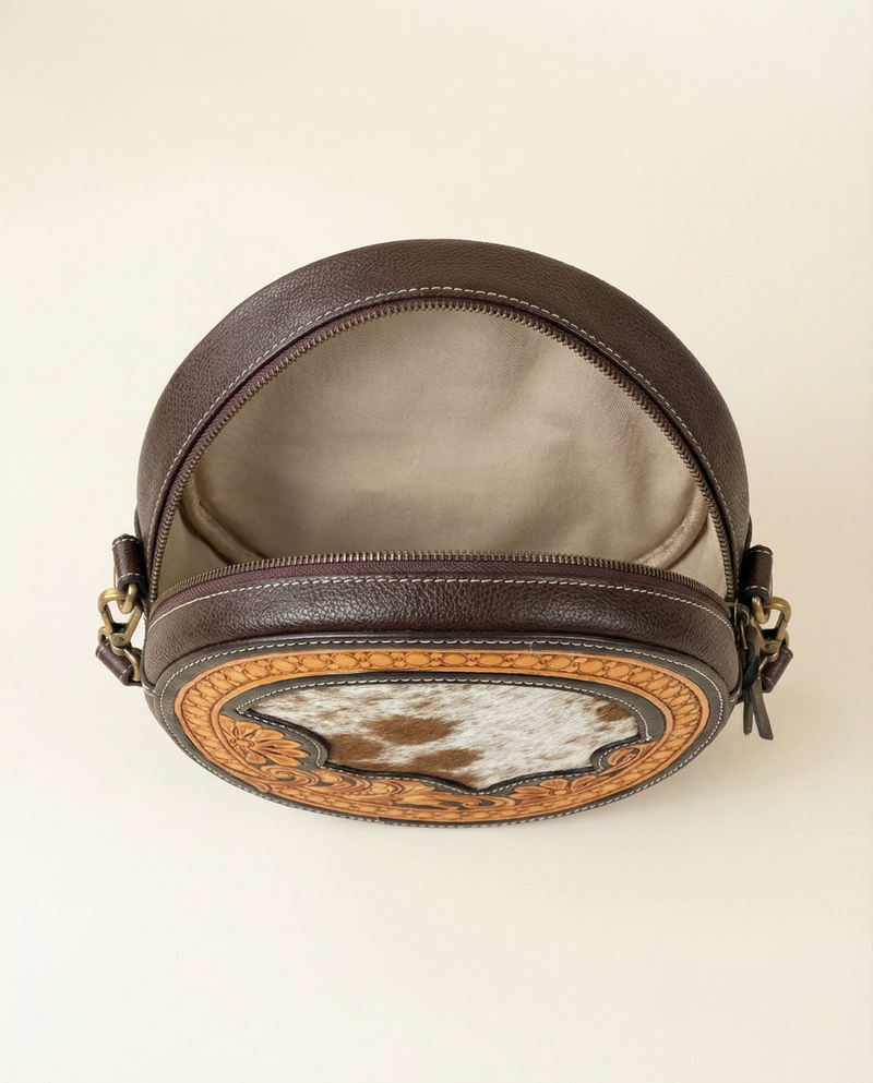 Hand-carved hair-on leather sling bag by Ya Qalbi
