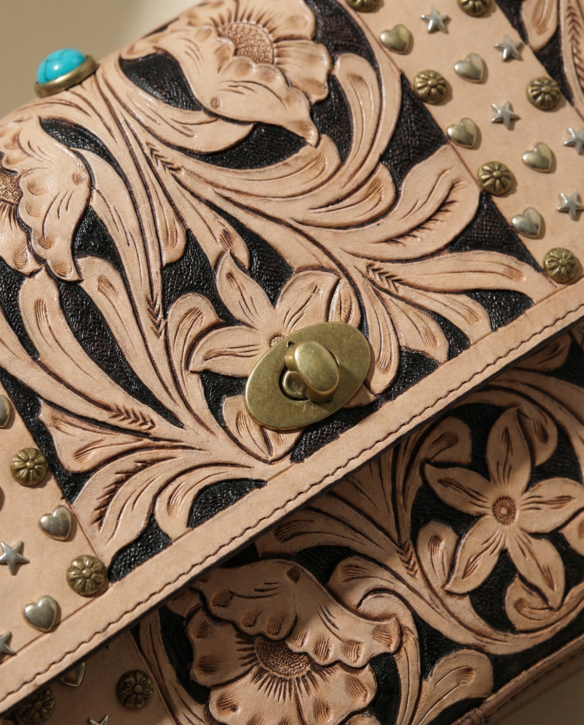 Tan tooled leather crossbody satchel with brass studs, stone and stud close-up, by Ya Qalbi