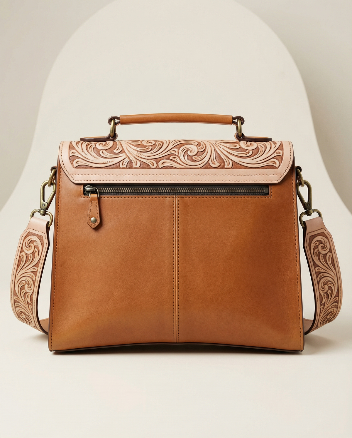 Back view of tan tooled leather satchel with tooled strap by Ya Qalbi