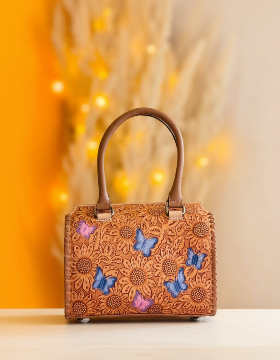 Blue sunflower hand-tooled leather barrel bag with painted butterflies, front view, by Ya Qalbi