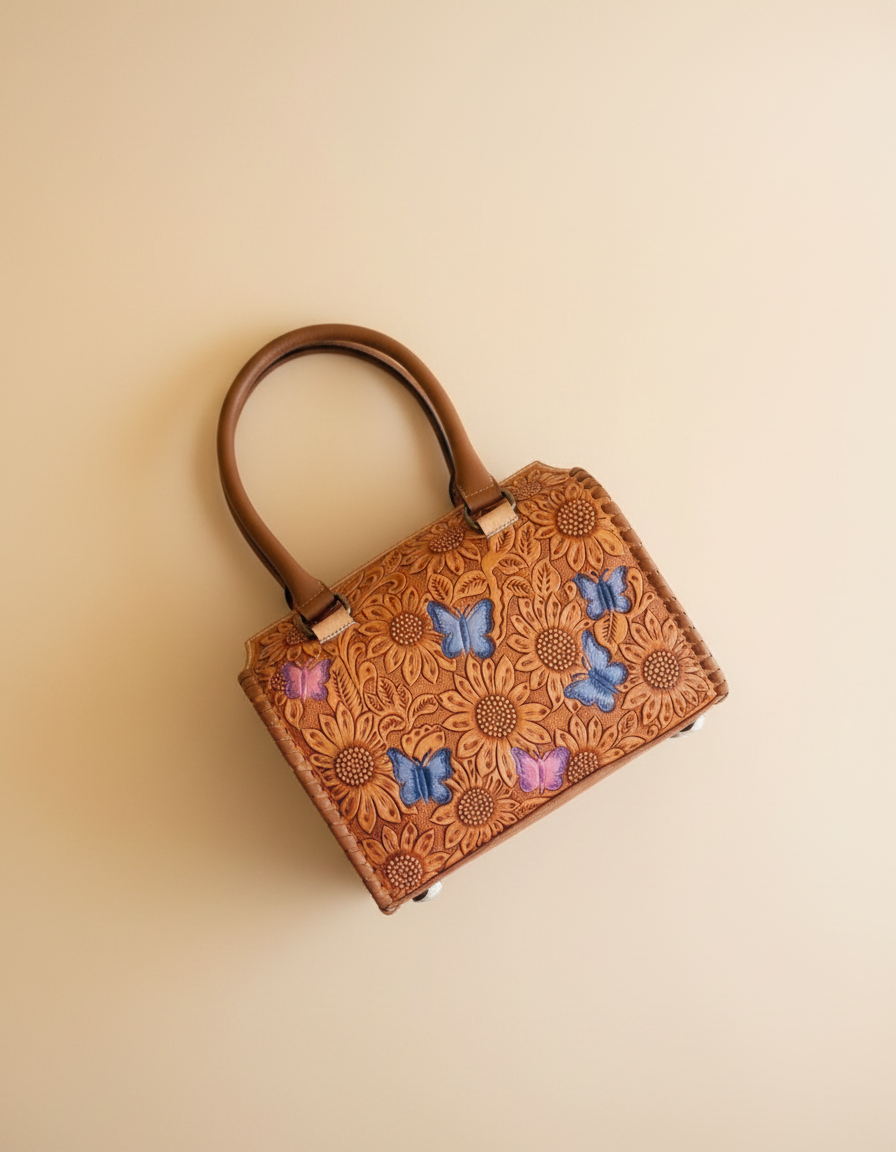 Blue sunflower hand-tooled leather barrel bag with painted butterflies, detail close-up, by Ya Qalbi