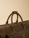Brown leather travel bag with trolley sleeve by Ya Qalbi