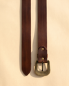 Full grain brown leather belt with scroll feather carving and antique brass buckle