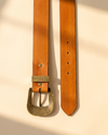 Full grain tan leather belt with Aztec southwestern geometric carving and brass buckle