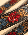 Handmade cowgirl belt with rose, leaf, and floral scroll painting on black leather
