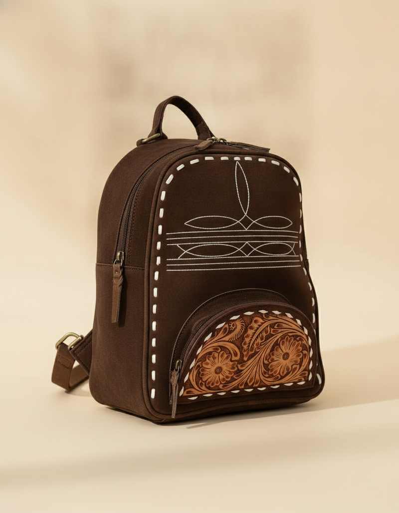 Dark brown suede backpack with white boot stitch embroidery, buckstitch lacing and tooled leather floral front pocket