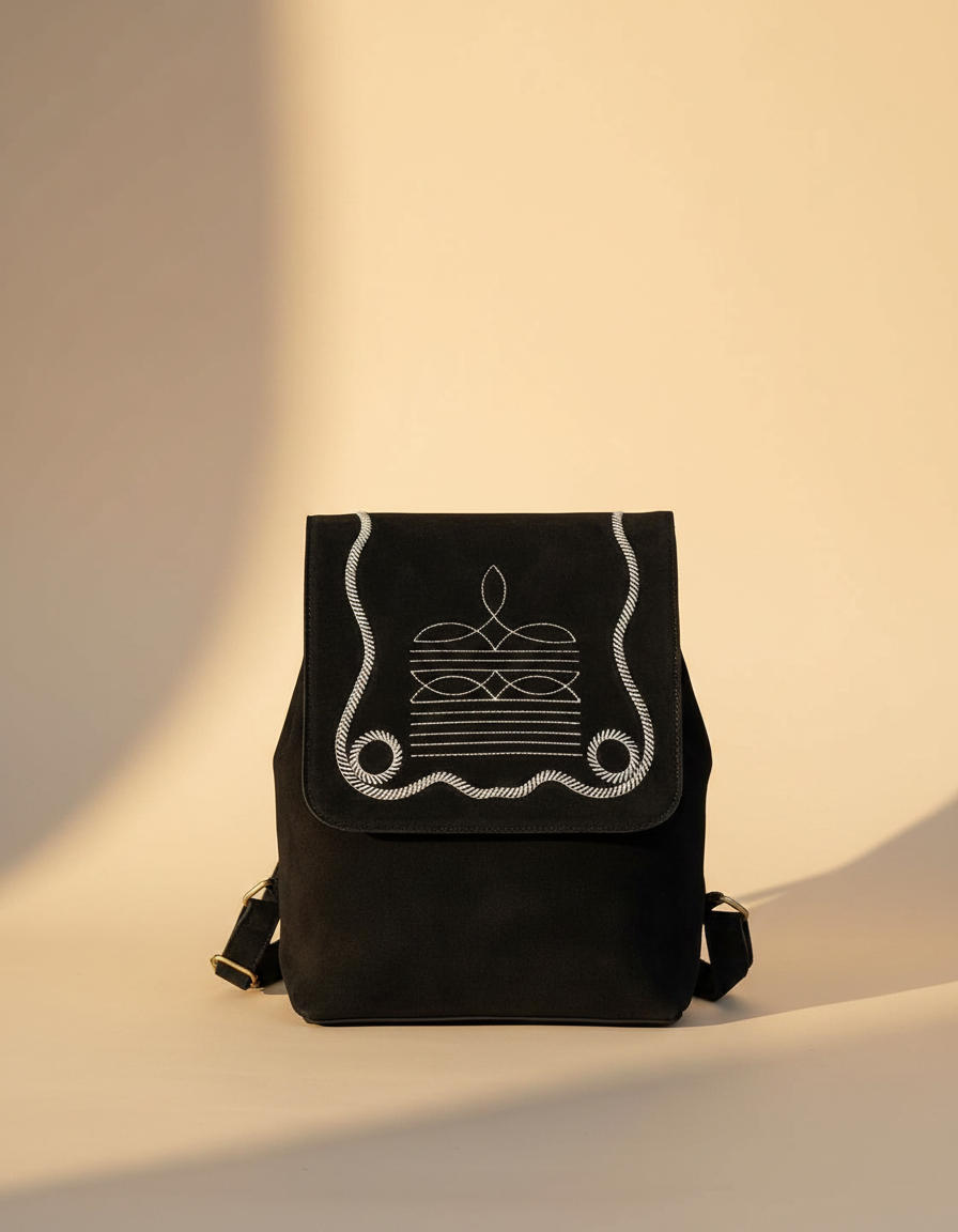 Black suede flap backpack with white bootstitch, front view