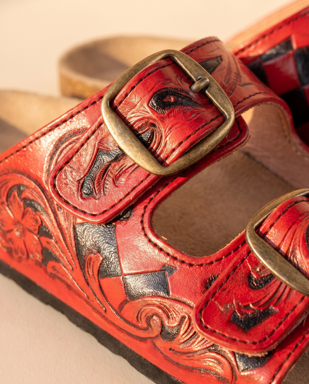 Close-up of red floral carving and black diamond panel