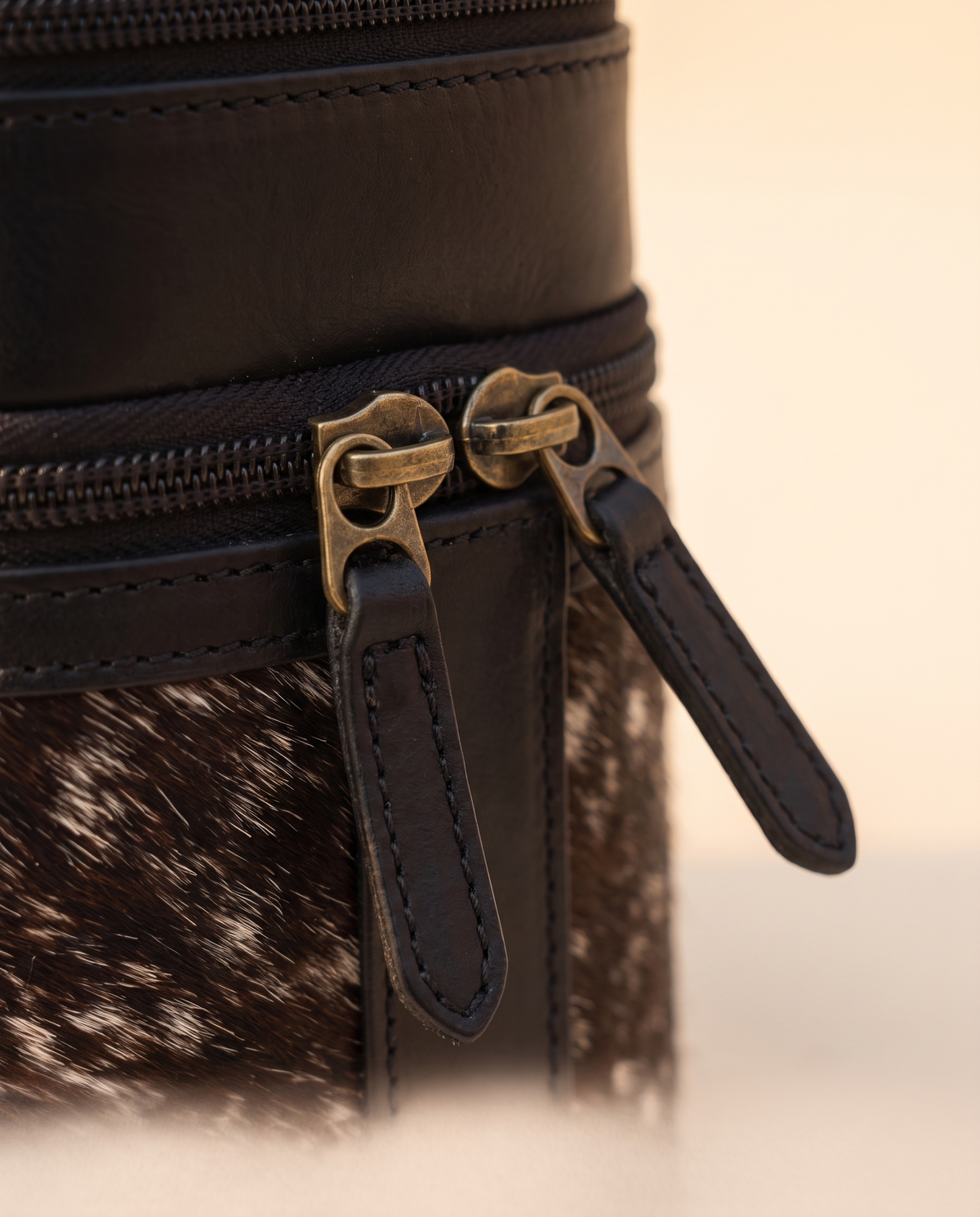 Zip pull detail on salt and pepper makeup case