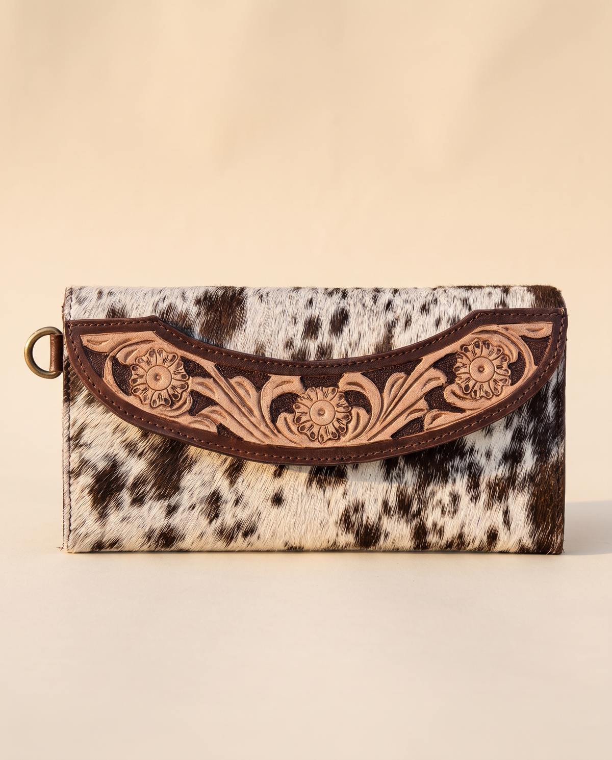 Brown cowhide wallet with curved hand-tooled flap, detail close-up, by Ya Qalbi