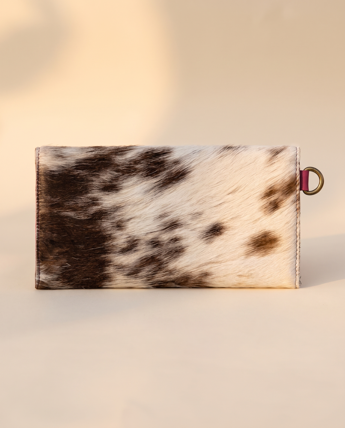 Pink cowhide wallet with curved hand-tooled flap, back view, by Ya Qalbi