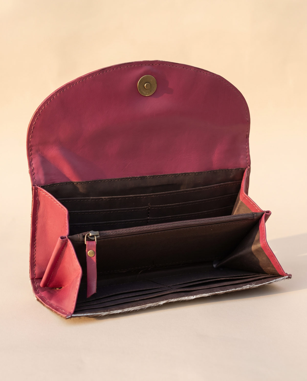 Pink cowhide wallet with curved hand-tooled flap, open interior view, by Ya Qalbi