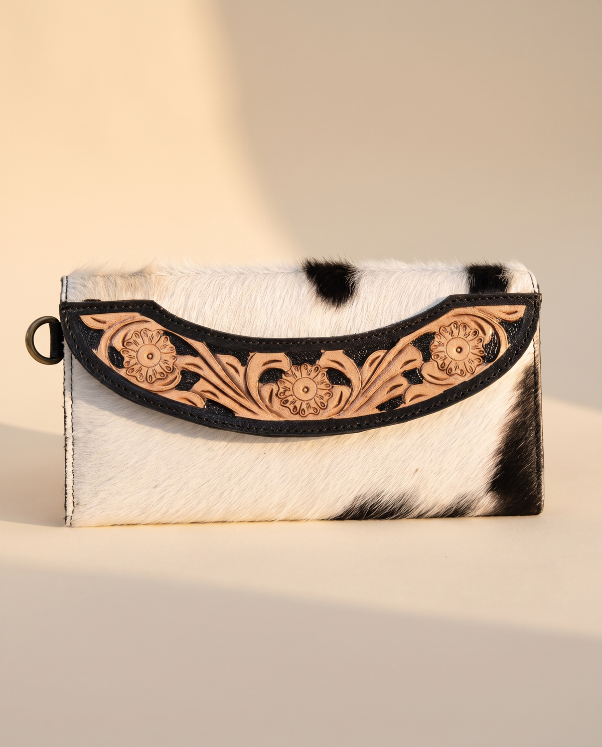Black cowhide wallet with curved hand-tooled flap, front view, by Ya Qalbi