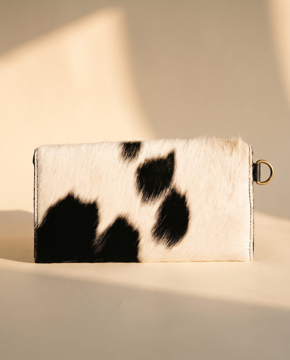 Black cowhide wallet with curved hand-tooled flap, back view, by Ya Qalbi