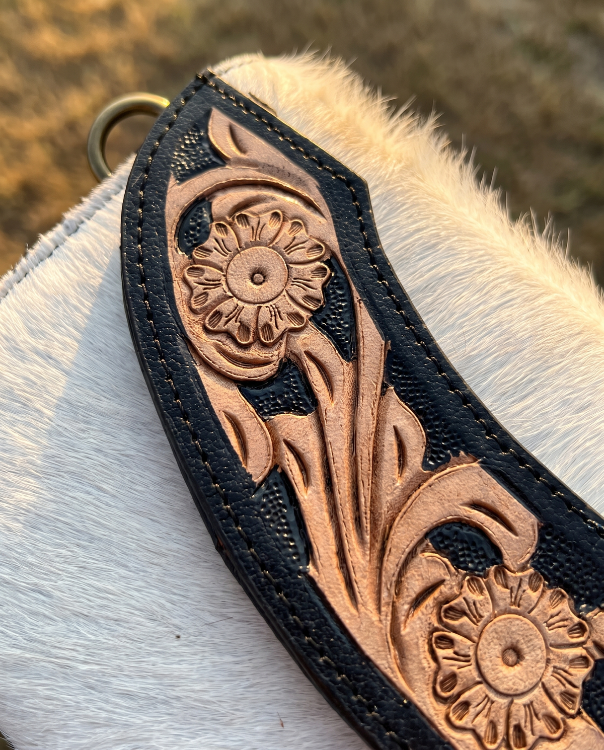 Black cowhide wallet with curved hand-tooled flap, detail close-up, by Ya Qalbi