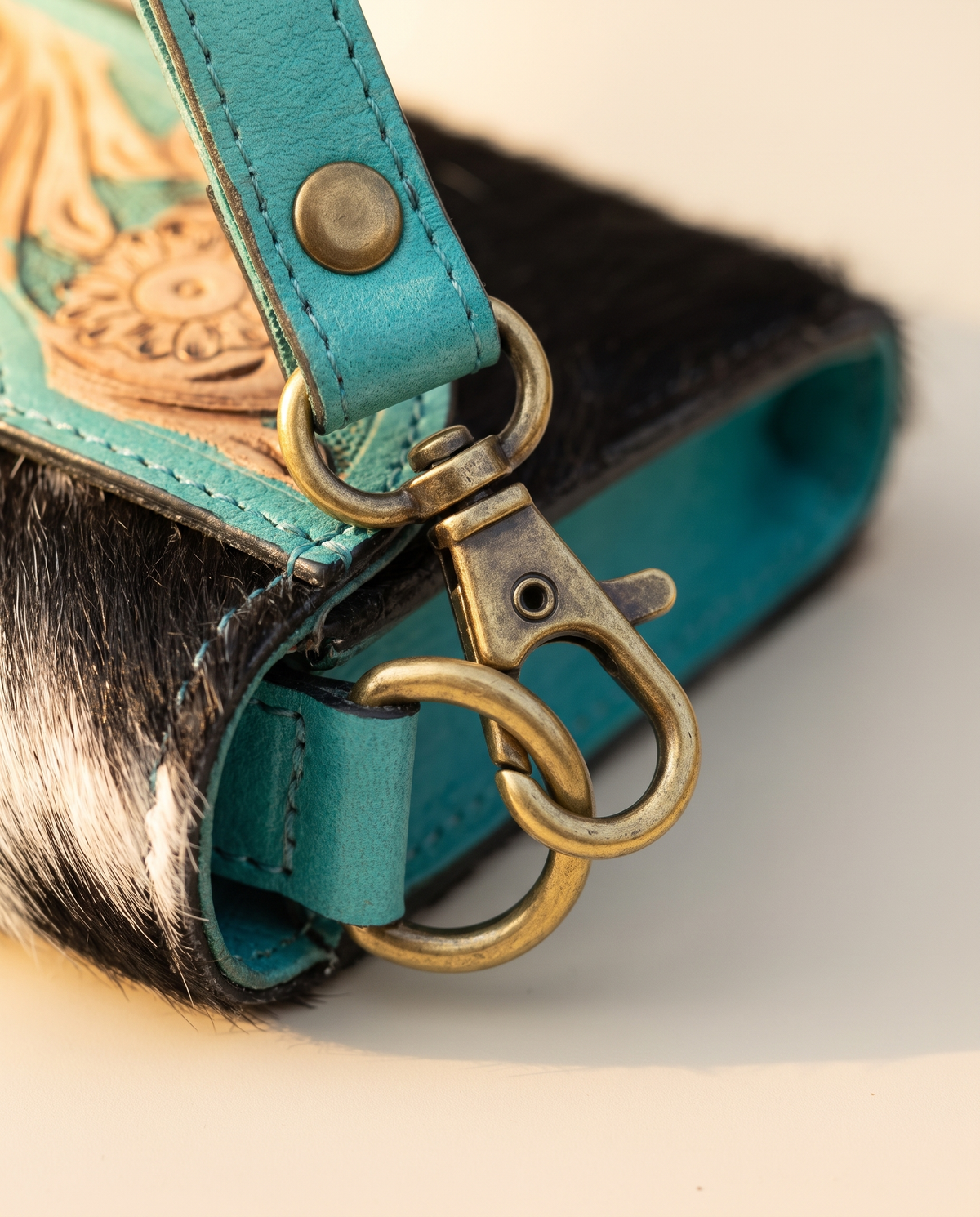 Turquoise cowhide wallet with curved hand-tooled flap, detail close-up, by Ya Qalbi