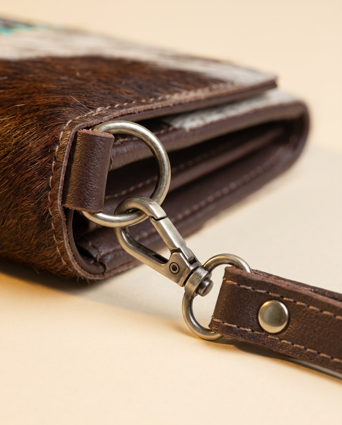 Brown and Turquoise cowhide wallet with bootstitch leather panel, angled view, by Ya Qalbi