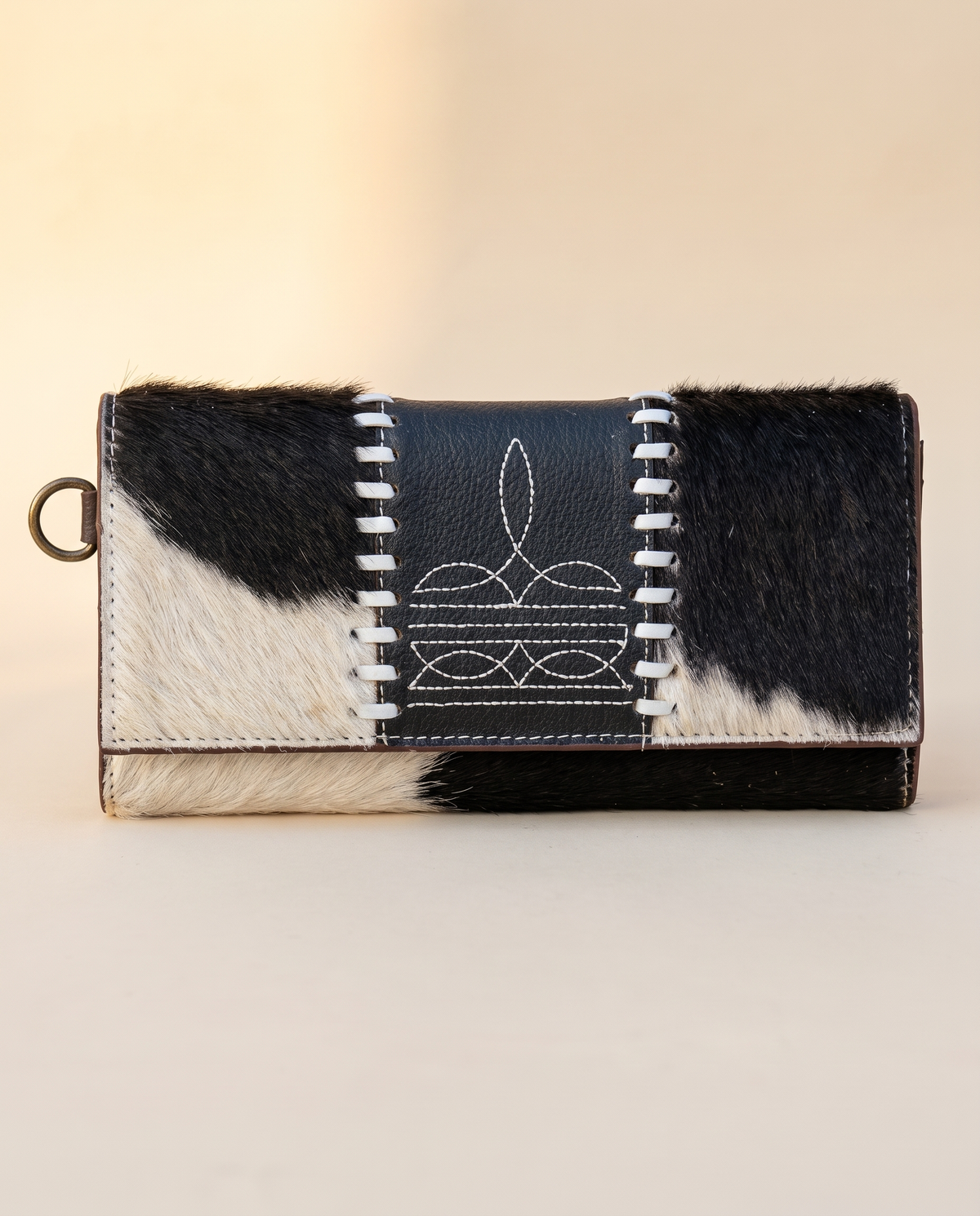 Black and White cowhide wallet with bootstitch leather panel, front view, by Ya Qalbi
