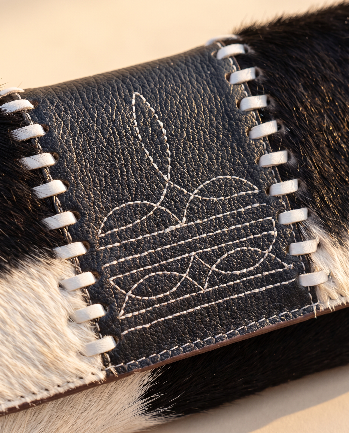 Black and White cowhide wallet with bootstitch leather panel, detail close-up, by Ya Qalbi