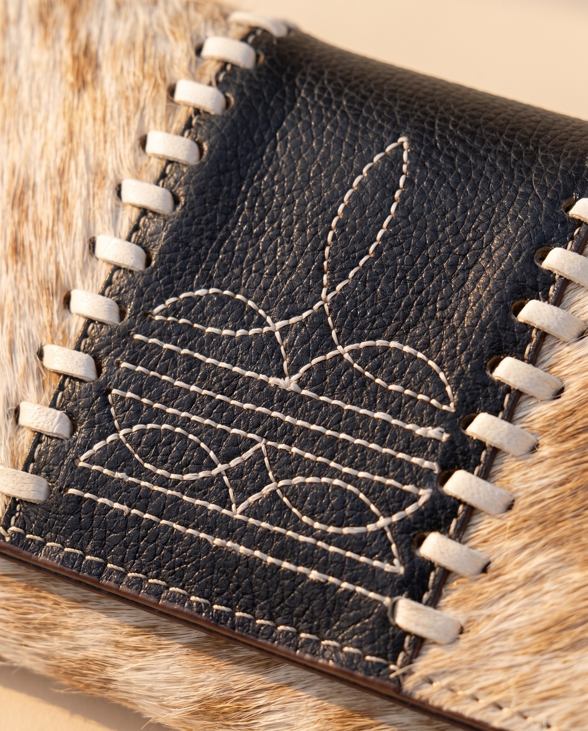 Tan and Black cowhide wallet with bootstitch leather panel, detail close-up, by Ya Qalbi
