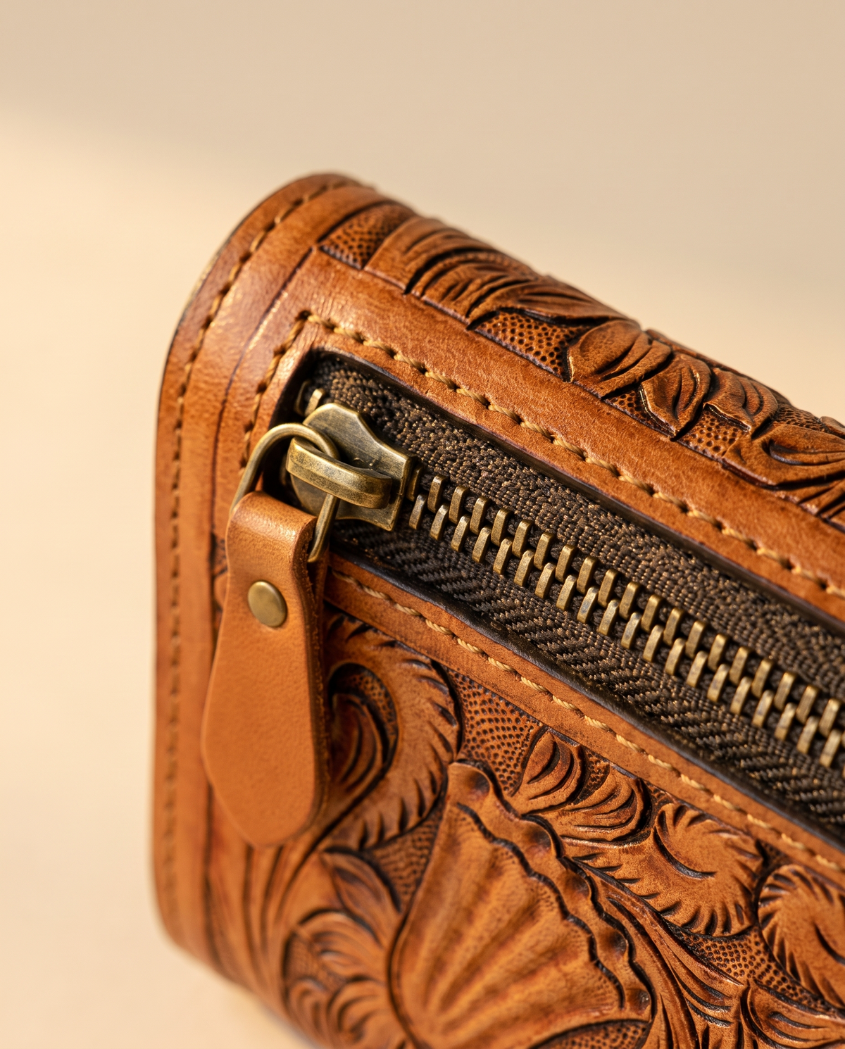 Tan hand-tooled leather zip wallet, detail close-up, by Ya Qalbi