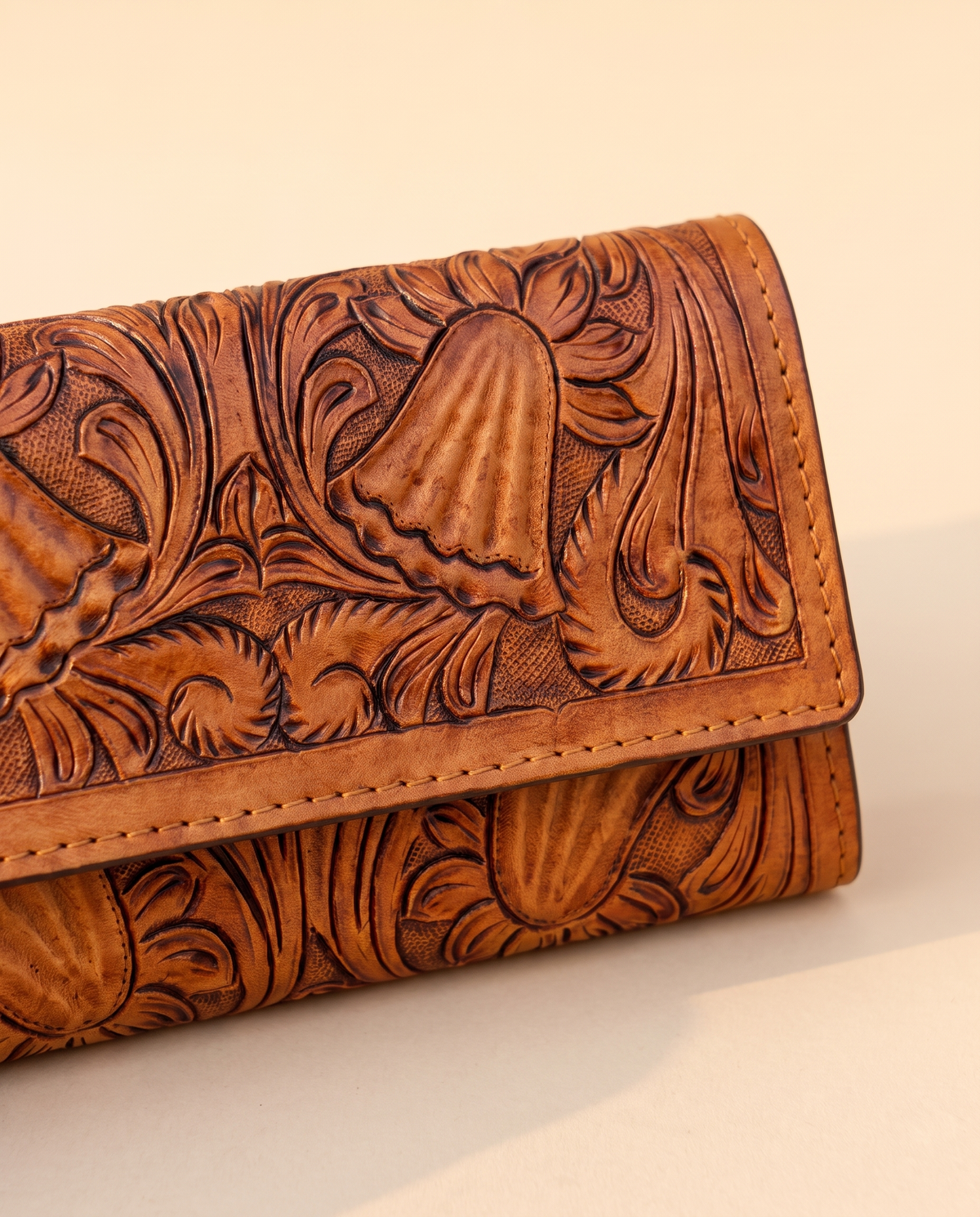 Tan hand-tooled leather zip wallet, detail close-up, by Ya Qalbi