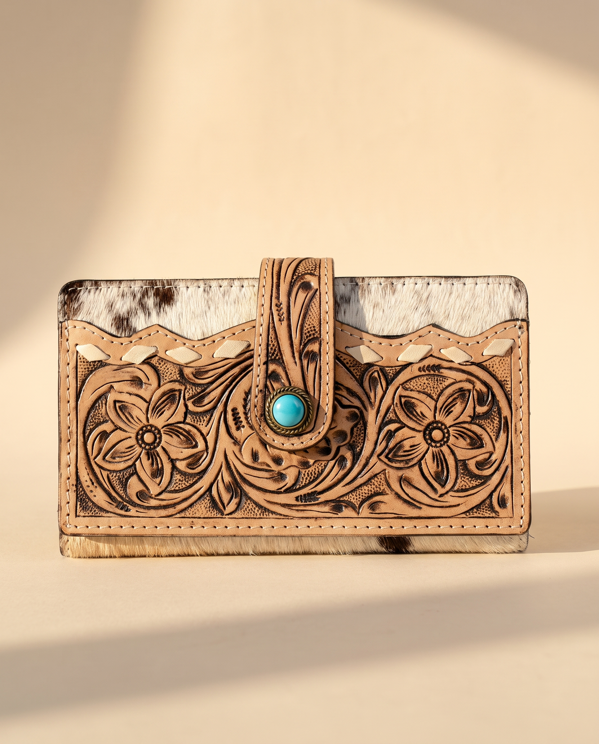Hand-tooled leather wallet with turquoise stone tab, angled view, by Ya Qalbi