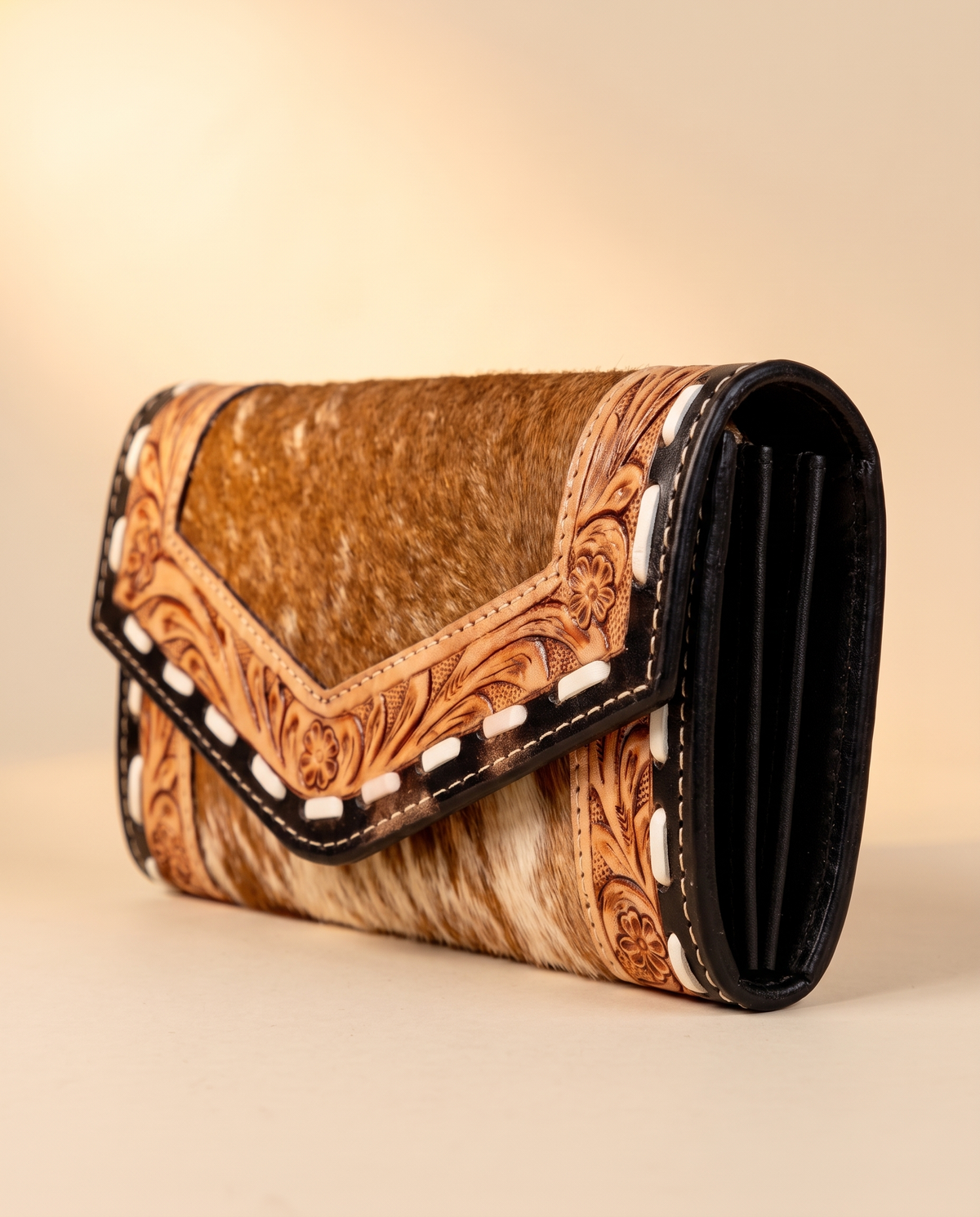 Cowhide envelope wallet with tooled whipstitch trim, angled view, by Ya Qalbi