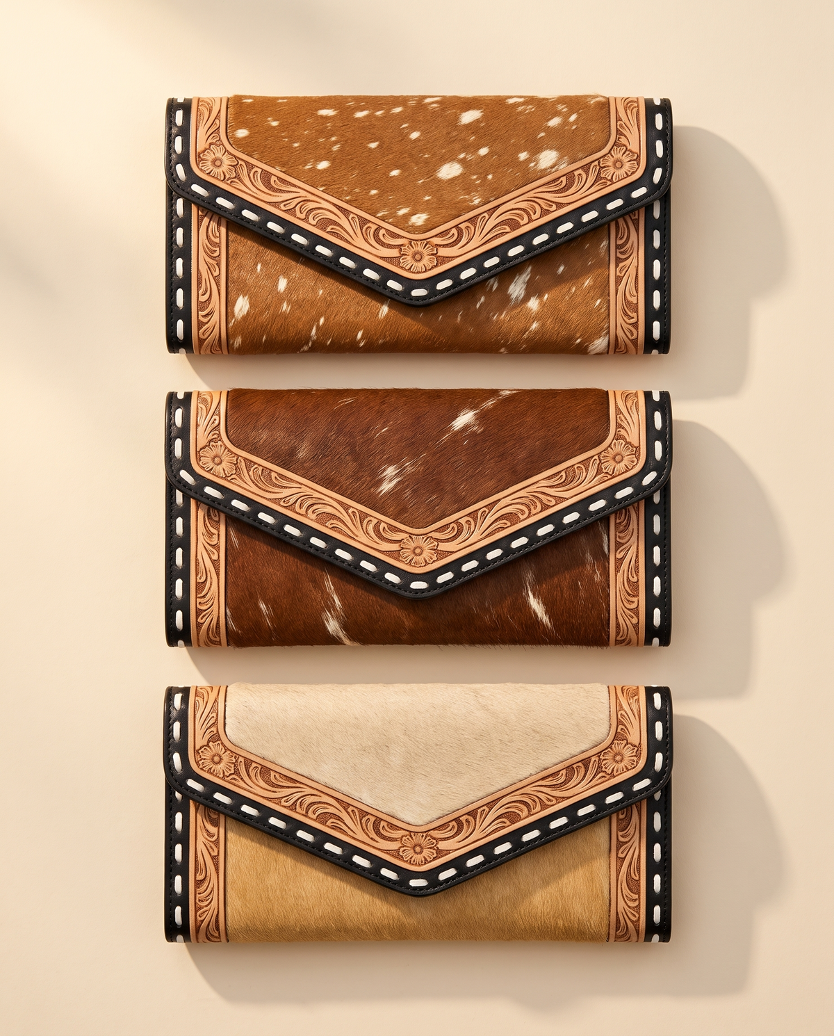 Cowhide envelope wallet with tooled whipstitch trim, group shot of colourways, by Ya Qalbi