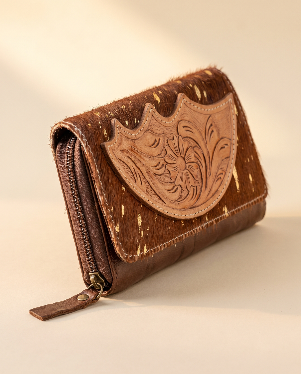 Cowhide wallet with scalloped hand-tooled flap, angled view, by Ya Qalbi