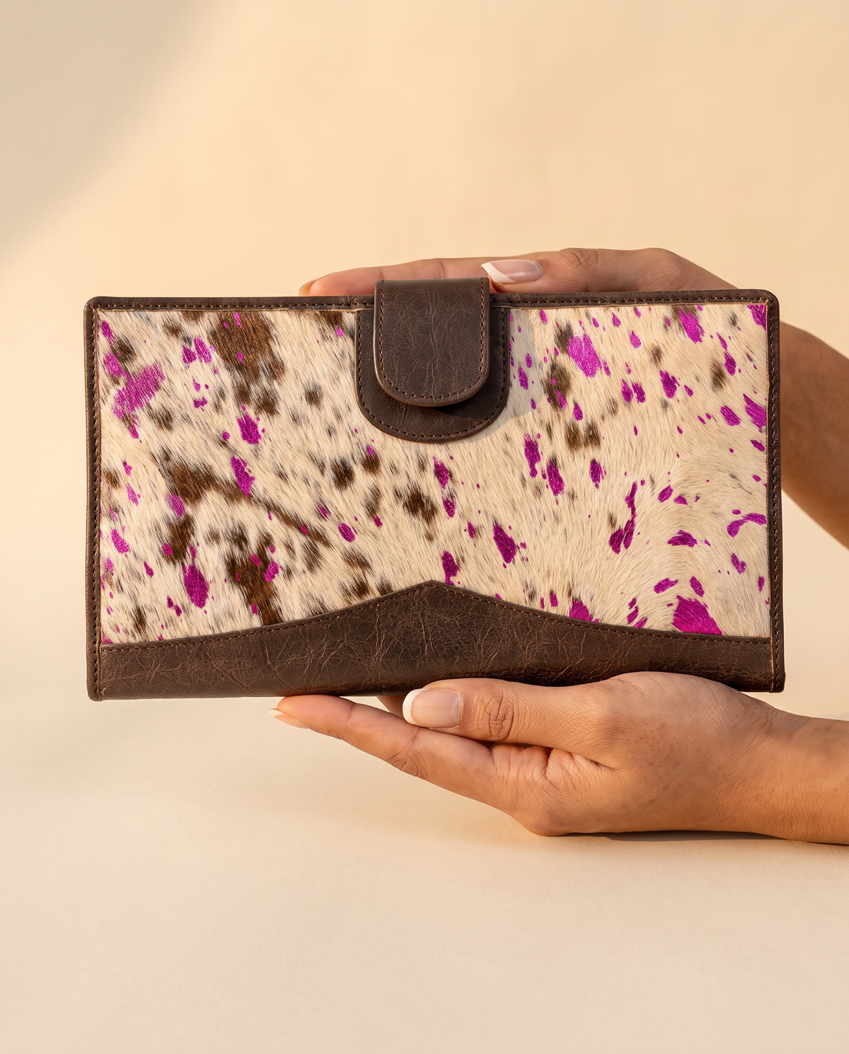 Metallic pink speckle cowhide wallet, held in hand, by Ya Qalbi