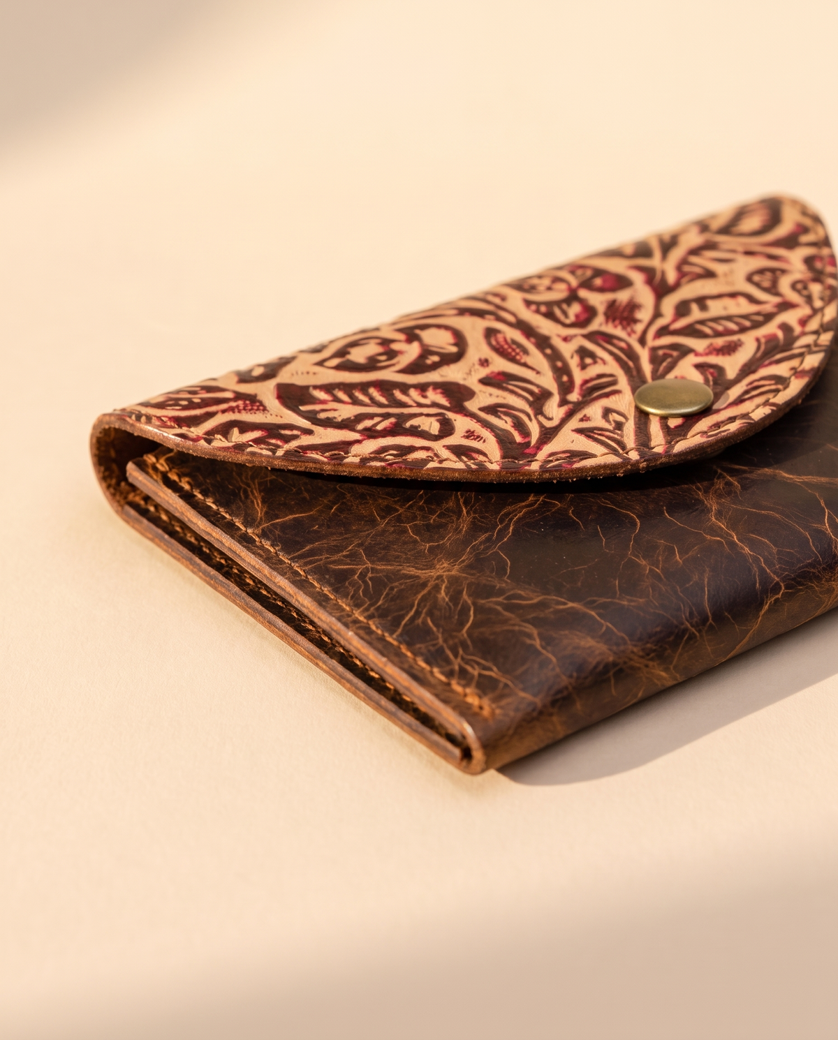 Crinkle brown leather wallet with tooled flap, angled view, by Ya Qalbi