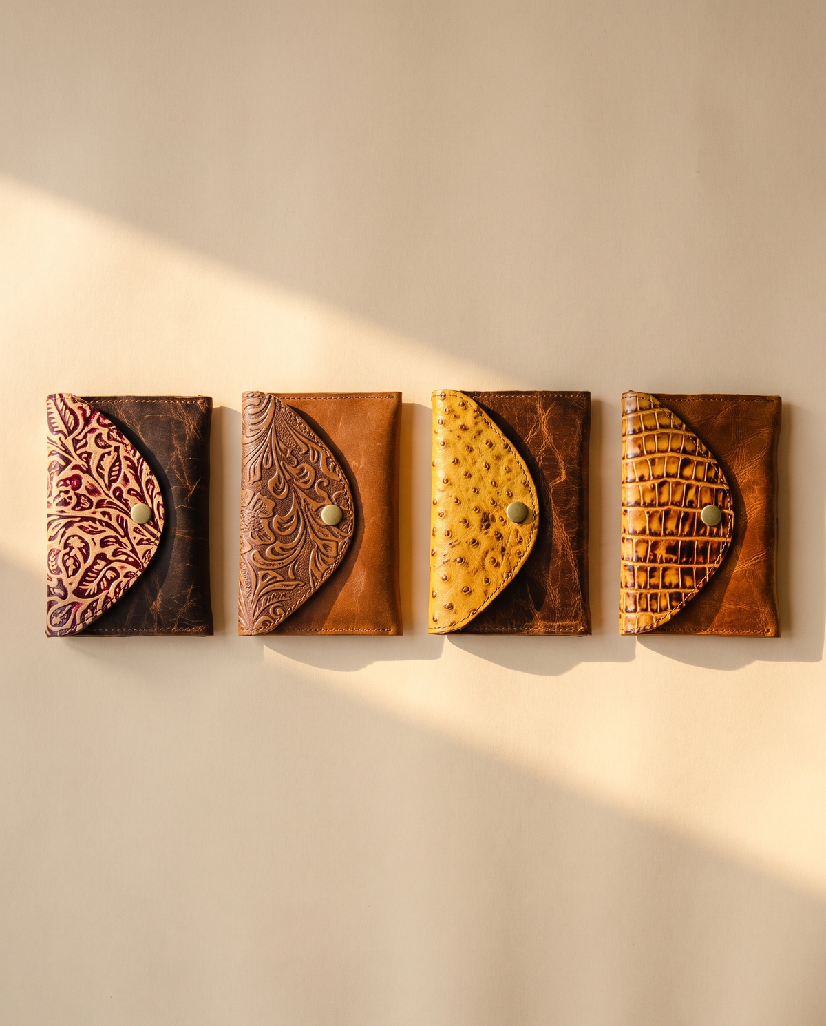 Crinkle brown leather wallet with tooled flap, group shot of colourways, by Ya Qalbi