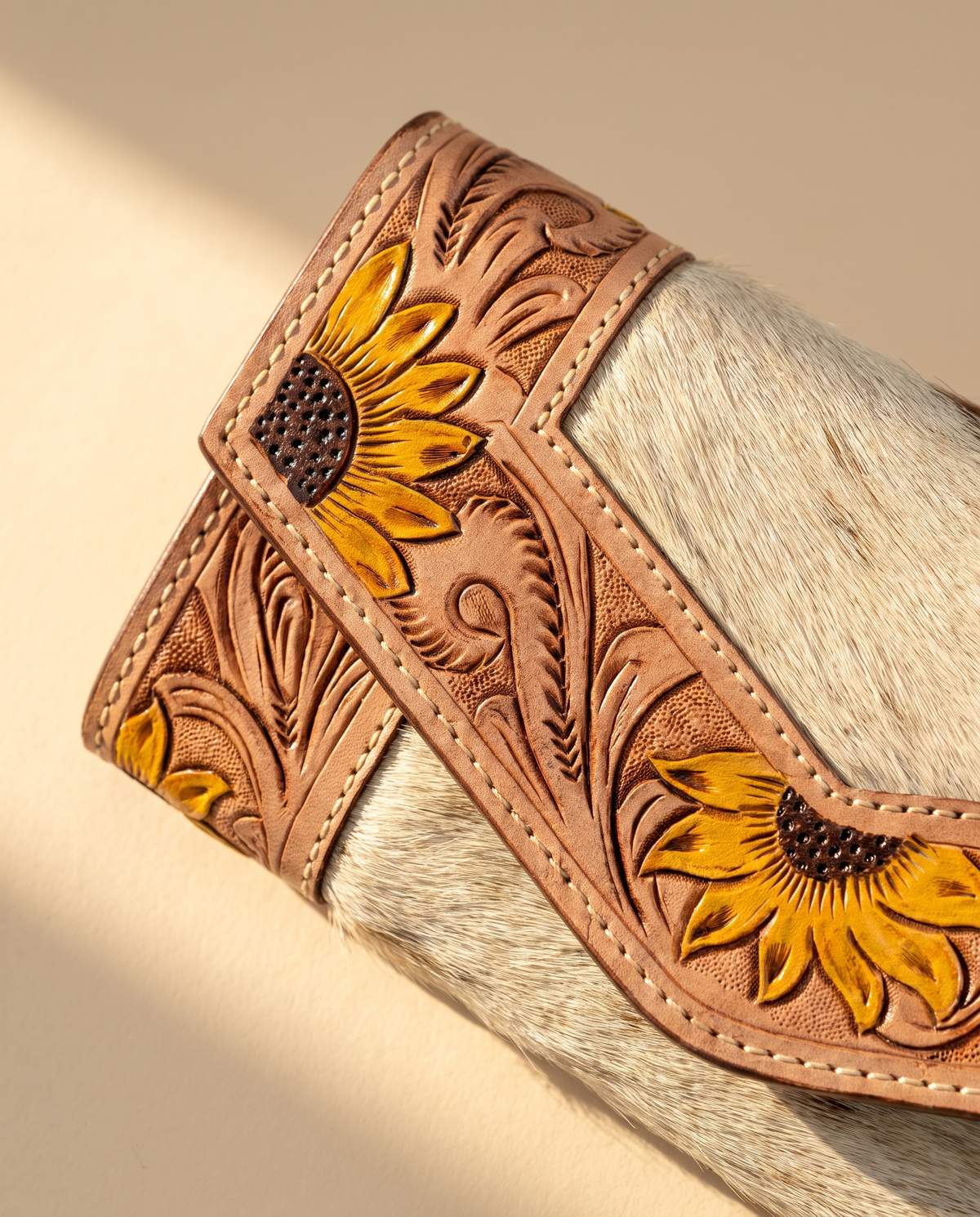 Cowhide envelope wallet with sunflower tooled frame, angled view, by Ya Qalbi