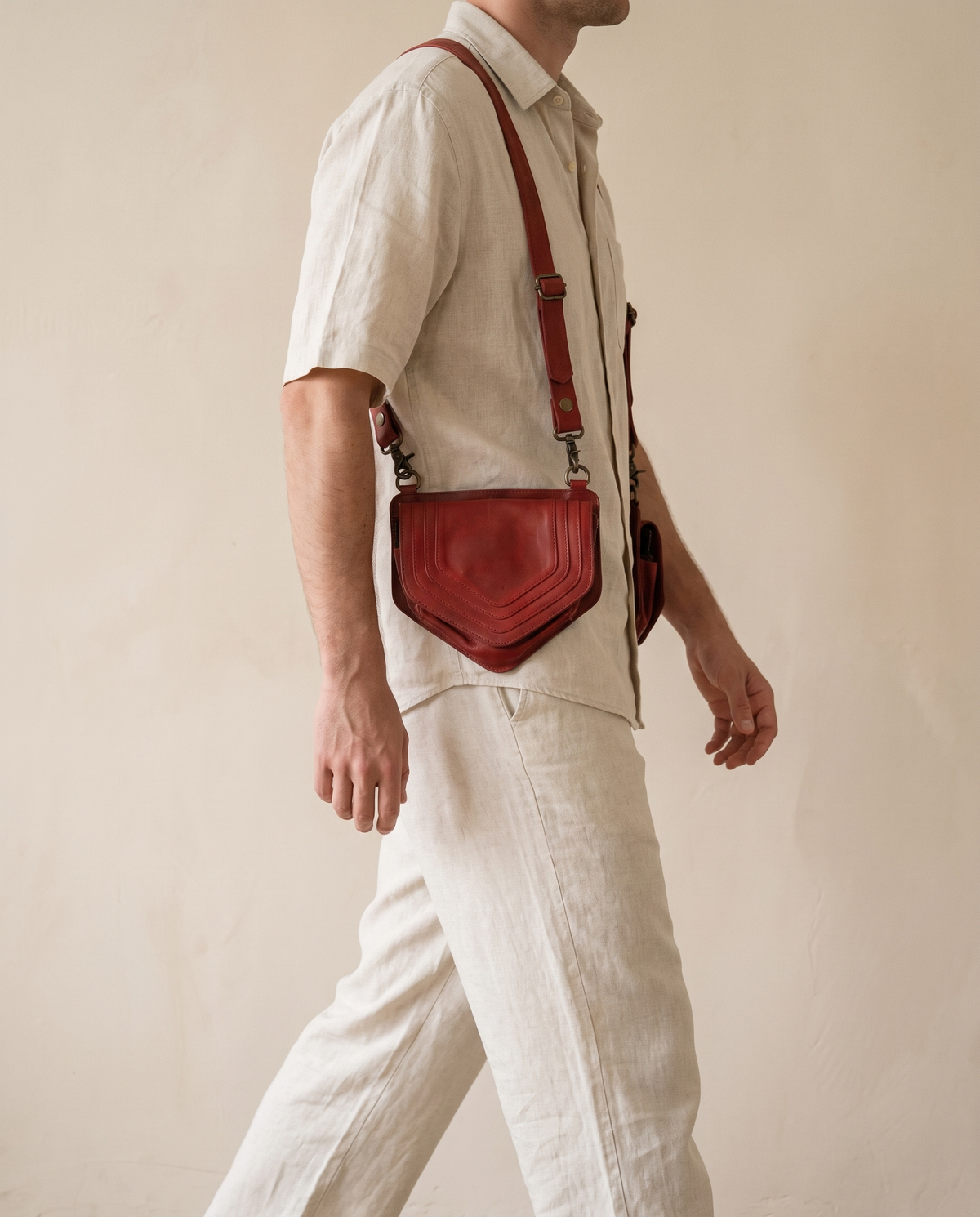 Red leather harness bag pouch, worn crossbody by a model, by Ya Qalbi