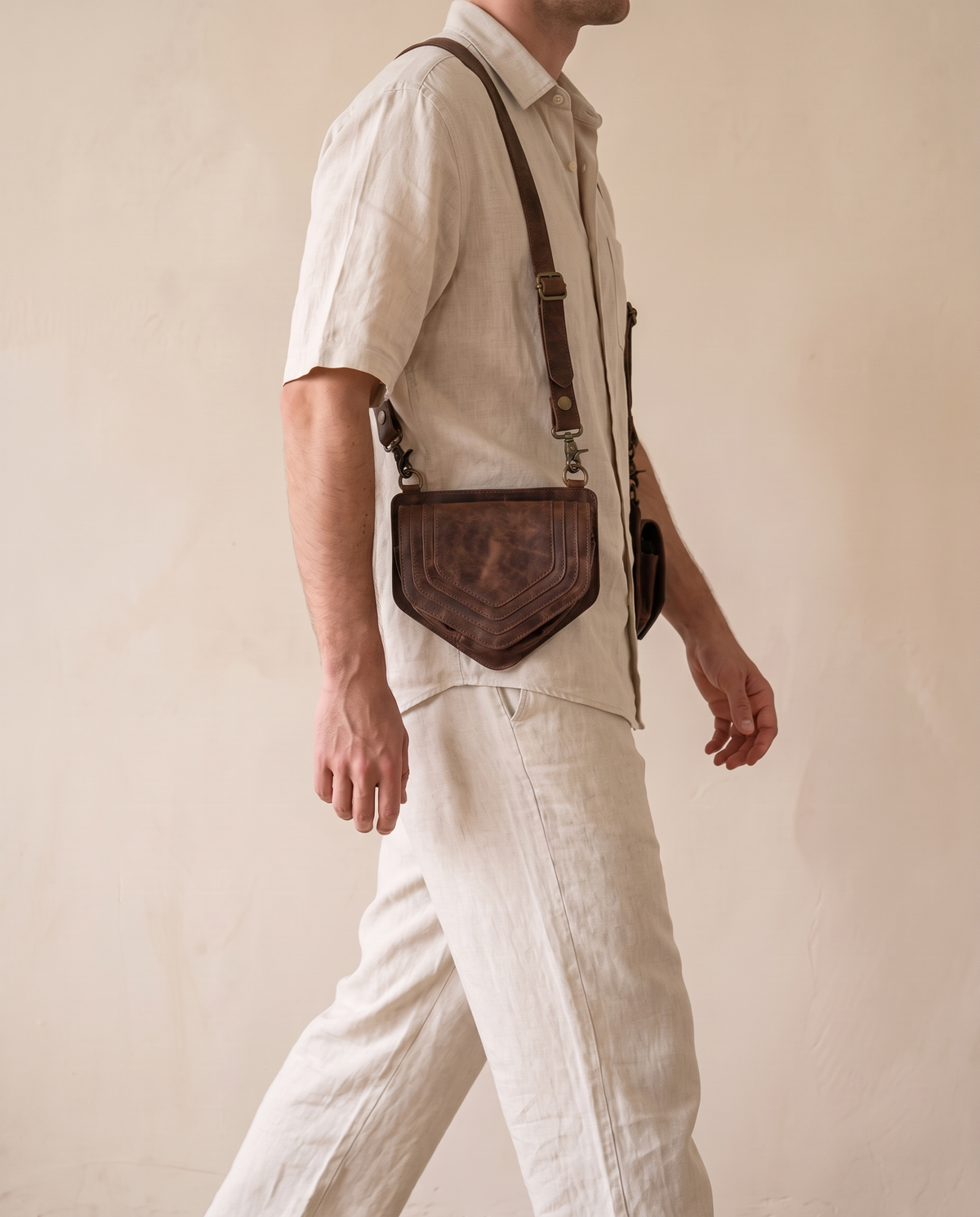 Dark brown and yellow hand-painted antler harness bag pouch, worn crossbody by a model, by Ya Qalbi