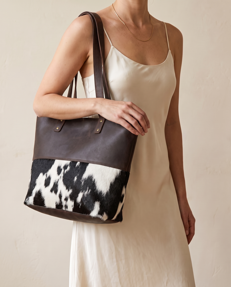 Model with black and white hair-on panel tote