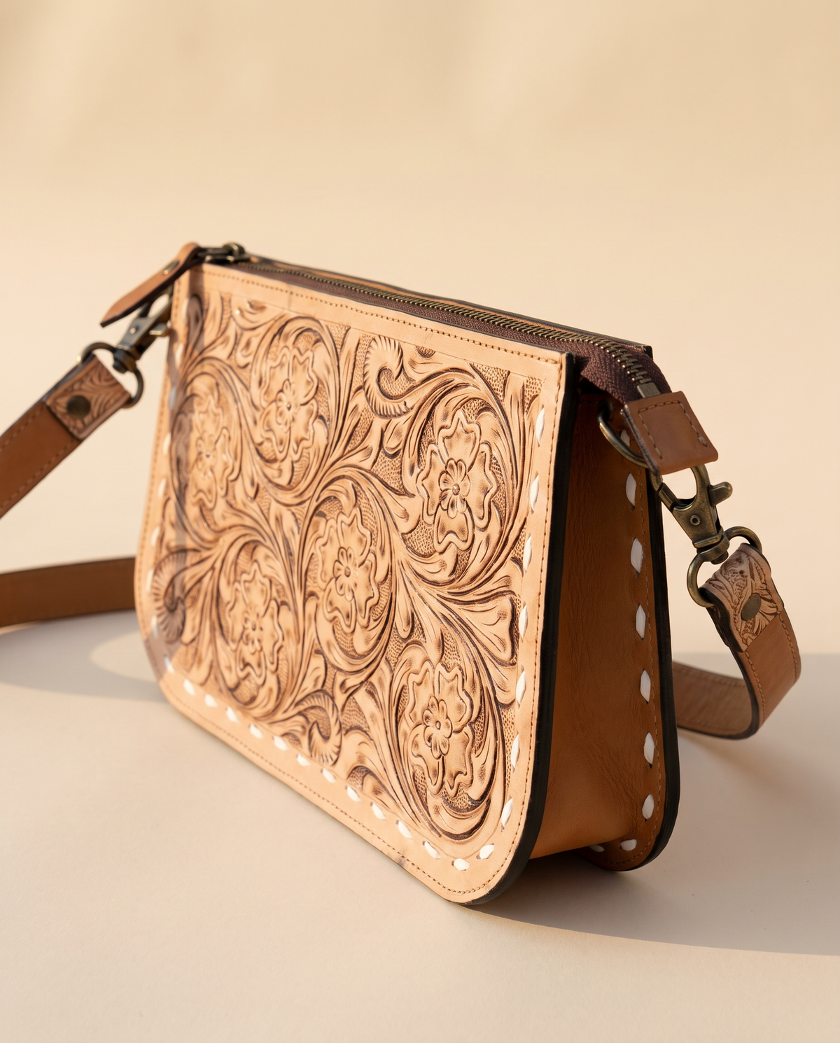 Tan tooled zip pouch, angled