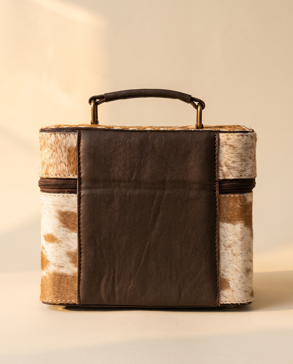 Brown hand-tooled leather vanity case with cowhide sides, detail close-up, by Ya Qalbi