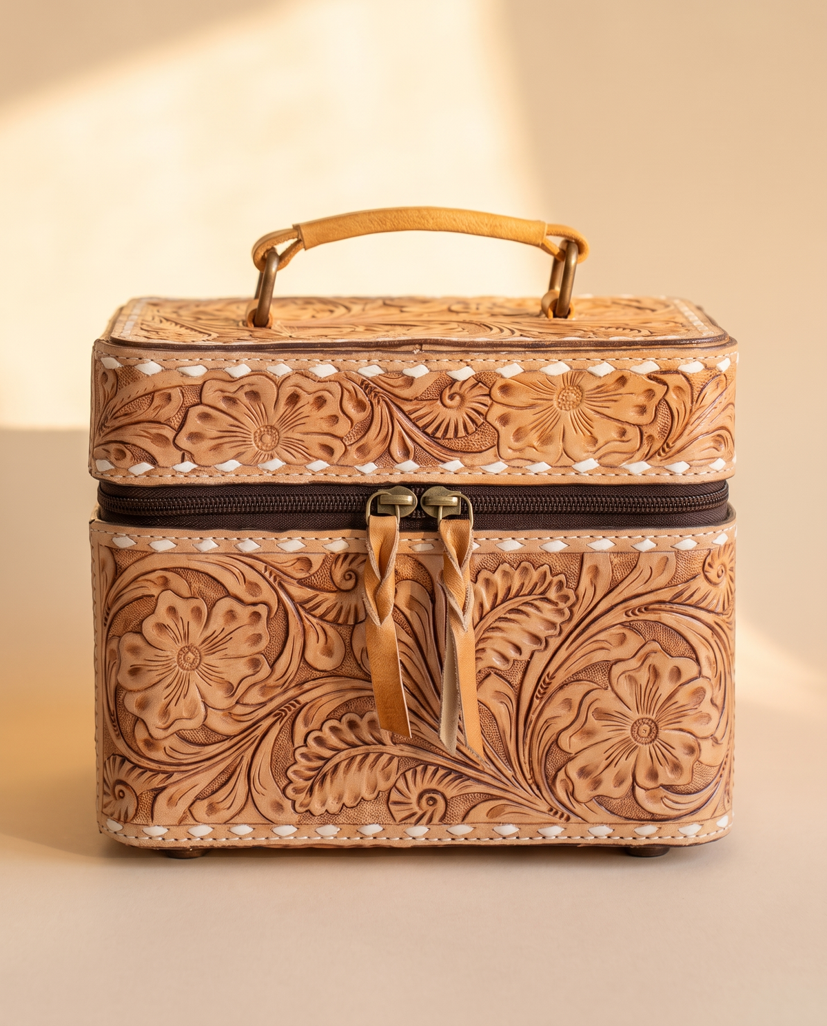 Tan hand-tooled leather vanity case with cowhide sides, angled view, by Ya Qalbi