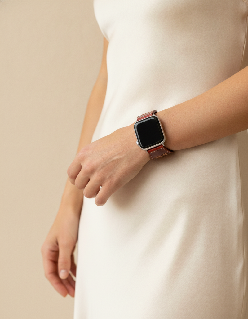 Red tooled watch strap on wrist
