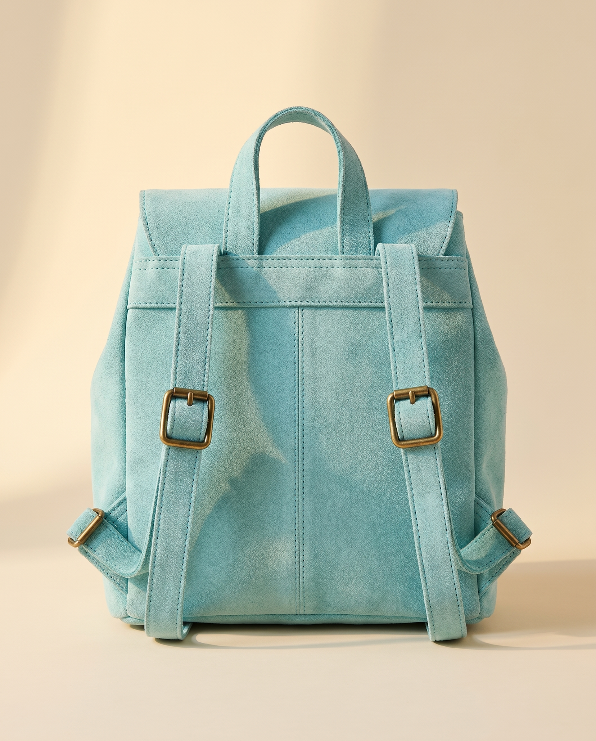 Back of turquoise suede drawstring backpack