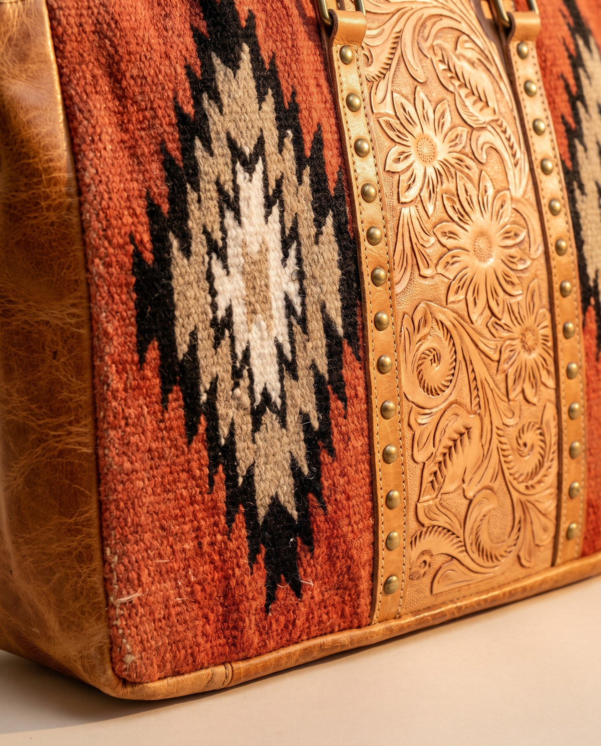 Rust Aztec woven leather zip tote with studded tooled strip, woven Aztec diamond and studs close-up, by Ya Qalbi