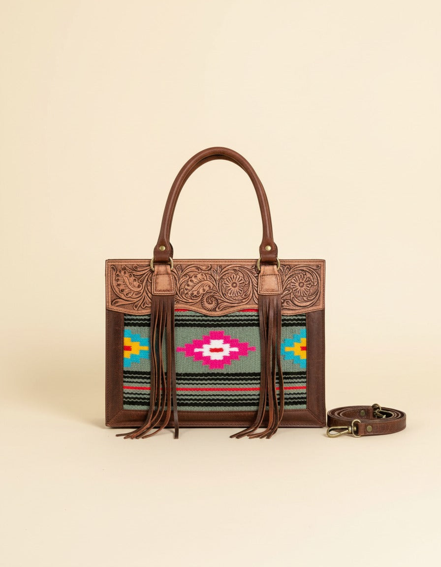 Grey and pink serape fringe tote with tooled leather top, front view with strap, by Ya Qalbi