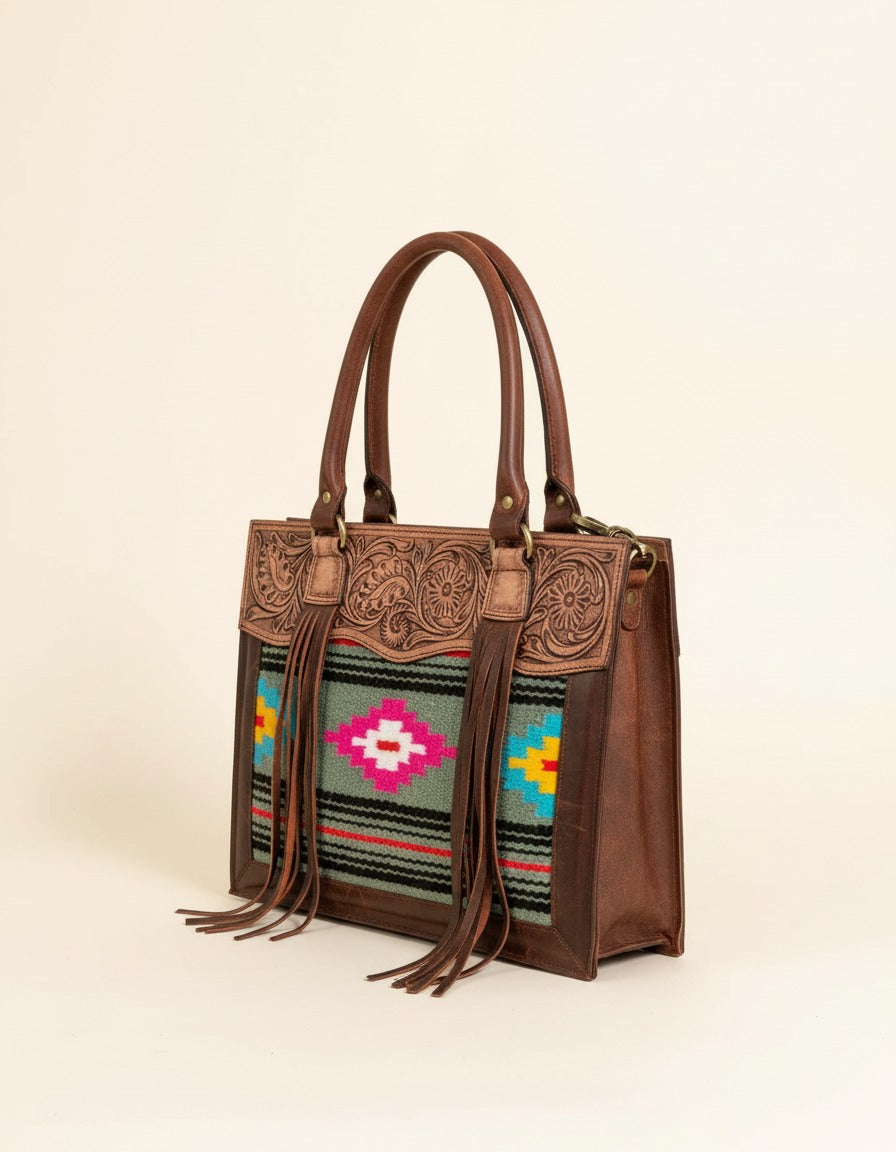Grey and pink serape fringe tote with tooled leather top, angled view, by Ya Qalbi