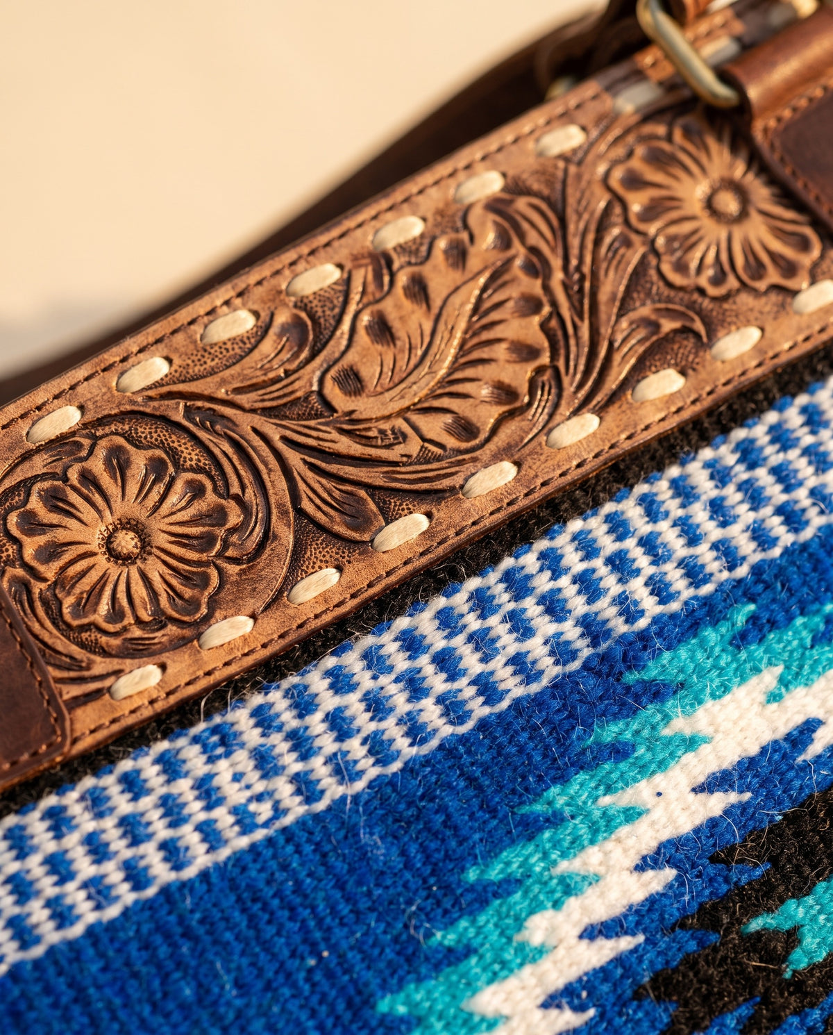 Blue serape woven zip tote with tooled leather band, tooled band and woven panel close-up, by Ya Qalbi