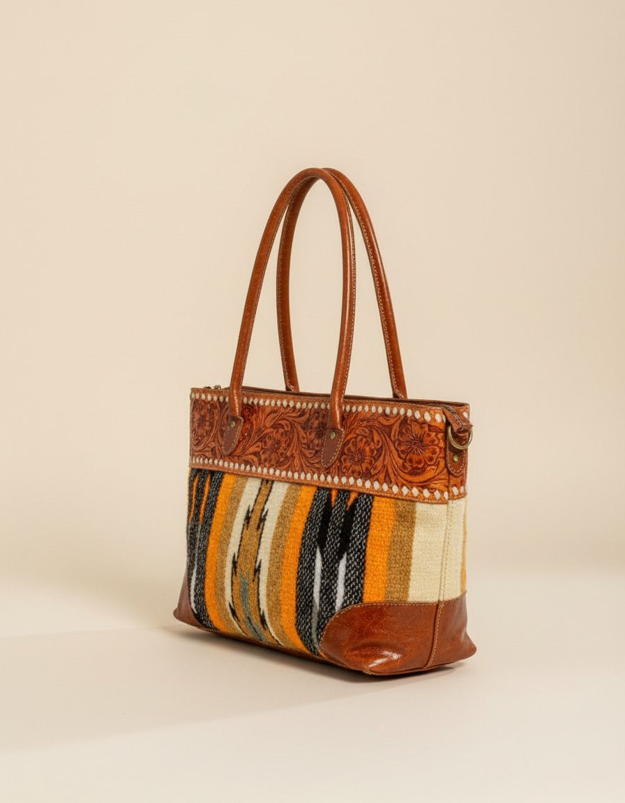 Mustard serape woven zip tote with tooled leather band, angled view, by Ya Qalbi